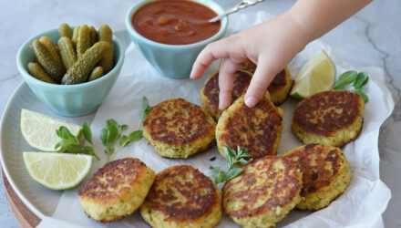 Fishcakes make with fresh Alaska Pollock on a large platter with sides.